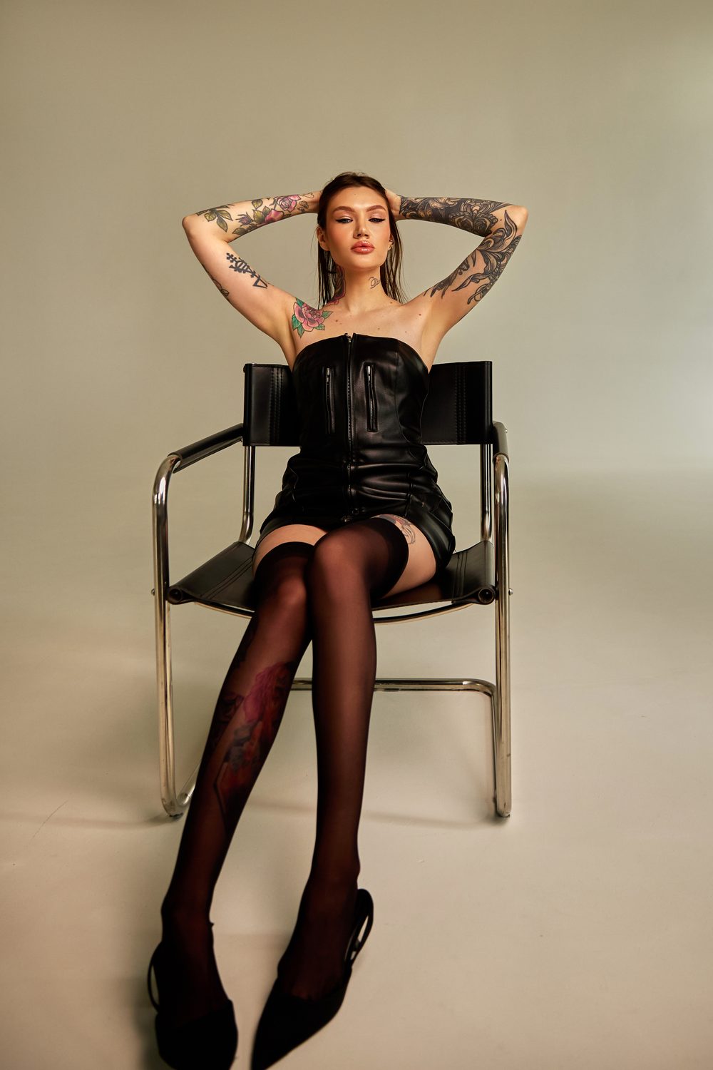Sasha Nelson sitting on a chair in lingerie